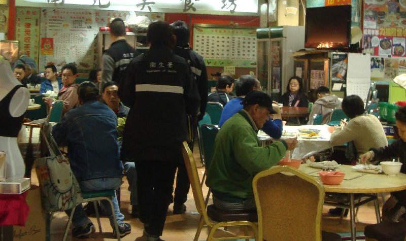 Tobacco Control Inspectors conduct an inspection at a cooked food centre.