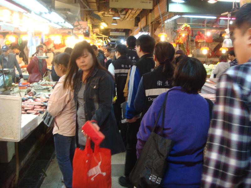 Tobacco Control Inspectors conduct an inspection at a market.